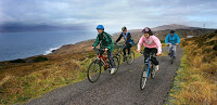 family cycling along a coastal country lane