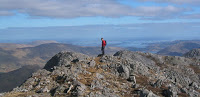 Hikers on the summit of a mountain along the Wild Atlantic Way.