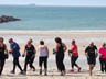 A group of pepole enjoying themselves on a local beach